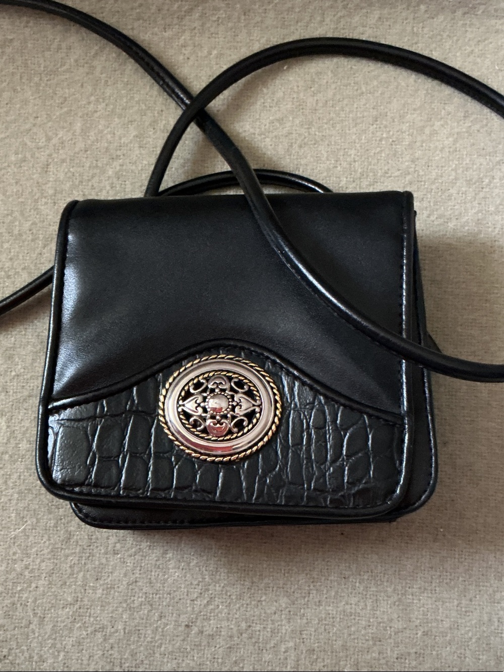 Black Crossbody Bag with Ornate Gold Medallion Accent